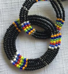 "Black and Multi color Indian style bead dangle earrings, with the small seed beads. They measure 3\" in height and almost 2\" in width. The way the circles are threaded there's a full circle hanging from a circle that's a vertical hoop, so they're perpendicular to each other. Also, please take a look at my storefront at: https://www.etsy.com/shop/FabFinds42?ref=seller-platform-mcnav I have a wide selection of one-of-a-kind items, from clothing and toys to home decor and gift items, and I add ne Orange Bracelet, Black Earrings Dangle, Multicolor Earrings, Retro Clock, Coral Bracelet, Black Seed, Indian Earrings, Beaded Dangle Earrings, Black Earrings