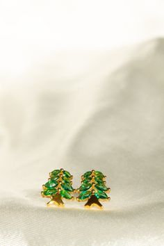 The Earth Collection was created as a token of love and appreciation of our homelands and mother nature. A new branch of the Homeland Ring Collection, the Earth Collection aims to admire and value naturalistic elements of Earth that are meaningful and valuable to one's homeland. The Cedar Tree studs were inspired by cedar trees native to the Meditteranean region. The tall and rich cedar tree is evergreen as it remains green throughout the year. Symbolizing power, longevity, and strength, the cedar tree is seen as a symbol of strength through turmoil. The trees are also seen to be meaningful in different cultures and religions throughout the world. Material:  18k Gold-plated Brass Top Grade 5A Quality Zircon Nickel Free and Hypoallergenic Lebanon Cedar Tree, Lebanon Cedar, Jewelry Emerald, Cedar Tree, Tree Jewelry, Emerald Green Earrings, Cedar Trees, Symbols Of Strength, Different Cultures