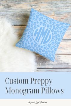 the monogram pillow is shown on top of a white fur rug and it's blue