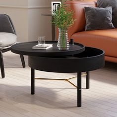 a living room with two chairs and a coffee table in the middle on hardwood flooring