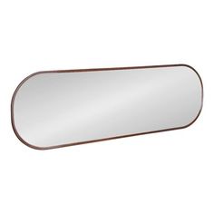 a mirror that is on top of a white wall and has a brown border around it