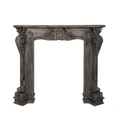 an antique style fireplace surround with carvings on the top and sides, in grey wood