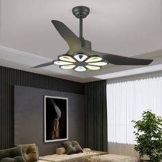 a living room with couches and a ceiling fan in the middle of the room