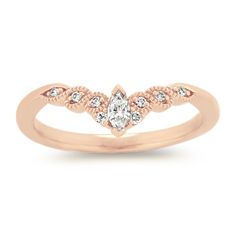 a rose gold ring with diamonds on it