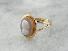 To complete this vintage ring, we've chosen an unusual, hefty cameo! This is a hard-stone cameo, a cameo carved not from shell, but from naturally banded agates, carnelians, or in this case, Sardonyx. The workmanship is detailed and lovely, and the simplicity of the gold setting allows the stone to be the centerpiece!Metal: 14K Yellow Gold Gem: Hardstone Cameo Gem Measurements: 13 x 9.5 mm Oval Ring Size: 9.25Marks: "14K A" Stamped on the inside bandSKU #: YPN3H7-NEach piece has been identified Bike Jewelry, Mens Ring Designs, Cameo Jewelry, Cameo Ring, Oval Ring, Men's Rings, Vintage Ring, Gold Set, Engraved Rings