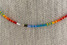 a multicolored beaded necklace on a mannequin