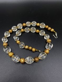 The Beautiful Crystals Quartz Beads Necklace Probably From Ancient Roman's or Greek's From Central Asian Countries Some Gold plated Wax and Some Brass Beads are Used As Spacers The Conditions Of Beads are Very Clearly Shown In the Pictures .Some Beads Got Some Damages that is due to Long Period Of times Price Is Negotiable So Please Do not Hesitate To Make an Offer Fast and Free Shipping Enjoy Beads Gold Faceted Bead Crystal Necklace, Gold Crystal Necklace With Large Round Beads, Formal Round Beaded Necklace With Spacer Beads, Formal Gold Beaded Necklaces, Gold Beaded Necklaces With Spacer Beads For Formal Occasions, Gold Single Strand Round Crystal Necklaces, Vintage Gold Beads For Festive Occasions, Elegant Gold Faceted Beads, Festive Vintage Gold Beads