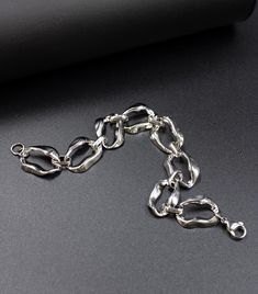 Our new stainless steel bracelet features a modern design crafted from lightweight twisted oval chain links. Each link in the chain is elegantly twisted, creating a dynamic interplay of light and shadow that adds depth and texture to the bracelet. The lightweight nature of the bracelet ensures comfort and ease of wear, while the twisted design provides a striking visual interest. The bracelet is hypoallergenic and waterproof. - MATERIALS - - polished stainless steel - SIZE- Bracelet is available Modern Polished Chain Link Bracelet, Modern Chunky Chain Bracelet, Modern Oval Link Chain Bracelets, Polished Oval Link Metal Chain Bracelet, Modern Oval Link Chain Bracelet With Polished Finish, Modern Stainless Steel Bracelet With Chunky Chain, Modern Silver Chain Bracelet With Oval Link, Trendy Silver Chain Bracelet With Solid Links, Modern Adjustable Chain Link Bracelet