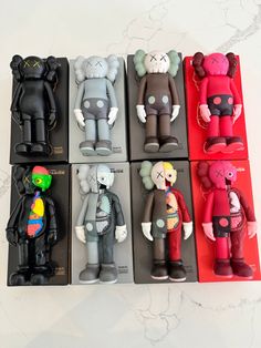 six different colored teddy bears sitting on top of each other next to each other in the same box