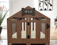 a wooden baby crib with a dog bone on the top