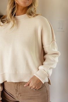 Featuring a drop-shoulder, ribbed material, and a high-low silhouette, the Leda Slouchy Pullover comes in two natural colors that are perfect for Fall. Pair easily with anything in your closet and be extra comfy in this slouchy pullover! high-low side slits black // paired with the sabine high rise wide leg jeans ivory // paired with the stellan wide leg pants Cozy Oversized Cropped Sweater With Ribbed Neckline, Oversized Cozy Cropped Sweater With Ribbed Neckline, Oversized Cropped Sweater With Ribbed Neckline, Oversized Ribbed Cropped Sweater For Layering, Cozy Ribbed Cropped Sweater In Relaxed Fit, Oversized Ribbed Cropped Cotton Sweater, Oversized Solid Ribbed Cropped Sweater, Oversized Solid Cropped Sweater For Layering, Beige Sweater With Ribbed Collar For Everyday