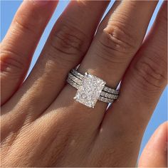 a woman's hand with two rings on it and a diamond ring in the middle