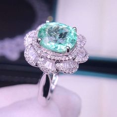 Rare Natural Paraiba Ring, Oval Cut 2.56ct Cyan Blue Tourmaline Ring with Real Diamonds, 18K solid White Gold, with CertificateThis 18k solid white gold ring is set with a marvelous 2.56ct Cyan Blue Tourmaline also called Paraiba with excellent fire and brilliance. The color of the Paraiba is a mysterious green-blue which is ultra rare and highly valued. This precious gem is surrounded with REAL diamonds on the band. This Ring is a wonderful piece of craftsmanship and one of a kind. The paraiba Luxury Tourmaline Ring With Center Stone, Luxury Oval Tourmaline Emerald Ring, Gia Certified Oval Topaz Ring For Gift, Gia Certified Oval Topaz Ring As Gift, Gia Certified Oval Aquamarine Jewelry, Oval Tourmaline White Gold Rings, Luxury Oval Emerald Ring With Moissanite, Oval Aquamarine Diamond Ring Fine Jewelry, Oval Aquamarine Diamond Ring In Fine Jewelry Style