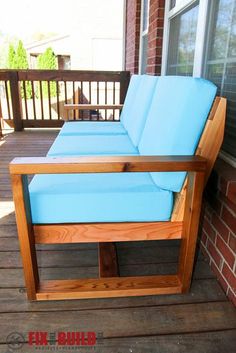 a couch sitting on top of a wooden deck