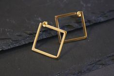 These 18k gold plated square earrings are great for casual or formal occasions such as weddings, graduations and birthday parties and would be an excellent gift for any jewellery lover. Your geometric earrings will come complete in a beautiful branded eco box ready for gifting. Size: 25 x 25mm We aim to dispatch all the orders on the same day so you can enjoy your jewellery without a long wait. Please visit our shop for more gold and silver jewellery. https://www.etsy.com/uk/shop/OnnanokoCo Modern Gold Plated Square Jewelry, Classic Gold Square Earrings, Elegant Rectangular Hoop Earrings For Formal Occasions, Elegant Gold Plated Square Jewelry, Modern Gold Square Earrings, Classic Gold Square Cut Earrings, Modern Square Gold Earrings, Modern Square Yellow Gold Hoop Earrings, Classic Square Yellow Gold Earrings