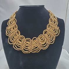 Signature Gold Braided Seed Bead Statement Necklace Gold Tone Claw Closure Gold Tone End Cap 1.5 Inch Width 17 Inch With 3 Inch Extender Elegant Adjustable Bib Necklace With Beaded Chain, Elegant Adjustable Beaded Chain Bib Necklaces, Elegant Gold Choker With Faceted Beads, Gold Beaded Costume Jewelry Necklace, Formal Gold Beaded Necklace, Adjustable Gold Bib Necklace With Beads, Gold Bib Necklace With Large Beads For Jewelry Making, Elegant Adjustable Bib Necklaces With Round Beads, Elegant Adjustable Bib Necklace With Round Beads