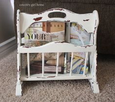 an old white magazine rack with magazines in it