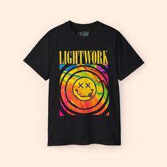 a black t - shirt with an image of a smiley face in the center and words lightwork on it