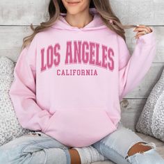 Wrap yourself in the laid-back and effortlessly cool vibes of Los Angeles with our Los Angeles Hoodie. This unisex hoodie is the perfect piece of apparel to show off your love for the city of angels. Made with high-quality materials, this hooded sweatshirt is comfortable and durable, making it ideal for everyday wear. Whether you're strolling along the palm-lined streets of LA or simply want to represent the city wherever you go, our Los Angeles Hoodie is a must-have. It also makes a great gift for anyone who appreciates California culture. Get yours today and let your LA spirit shine! 🖤 For oversized order 1-3 sizes up, refer to listing photos for sizes. RUNS ON THE SMALLER SIDE 🖤 Gildan 18500 🖤 Some Shrinkage may occur with washing 🖤 This unisex heavy blend hooded sweatshirt is relax Casual Hoodie With Letter Print, Leisure Hooded Hoodie With Letter Print, Hooded Letter Print Hoodie For Leisure, Casual Leisure Hoodie With Letter Print, Leisure Letter Print Hooded Hoodie, Trendy College Hoodie With Drawstring, Trendy College Hoodie, Casual Hoodie Sweatshirt With Letter Print, Trendy College Hooded Sweatshirt