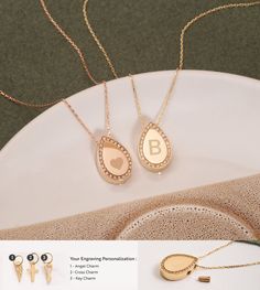 two necklaces and earrings on a plate with other jewelry items in front of it