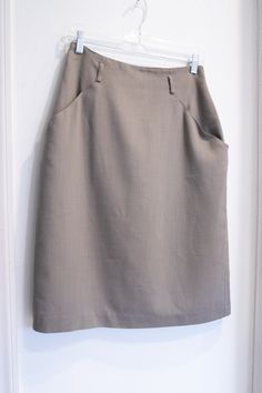 "This Vintage 1990's Short Olive Khaki High Waist Pencil Skirt is in good vintage condition. There are a few small age spots on the fabric that are hardly noticeable. This adorable pencil skirt is lined with a champagne-colored fabric. The tag says \"Michele\". There are two deep pockets, a metal zipper in the back, and four large belt loops. Lay Flat Measurements: Waist: 14 inches Hips: 20 inches Length: 25 inches" High Waist Pencil Skirt, Large Belt, Polka Dot Maxi Dresses, Womens Skirts, High Waisted Pencil Skirt, Boho Green, Age Spots, Pittsburgh Pa, Wrap Skirt