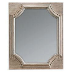 a large mirror that is on top of a wooden frame and has an ornate border around it