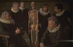 a group of people standing next to each other with a skeleton in front of them