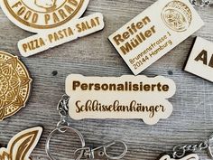 several wooden badges and key chains on a table