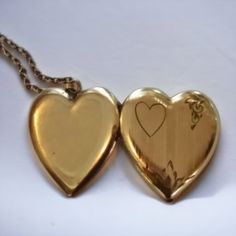 This antique Art Deco heart-shaped locket is crafted with the quality of a bygone era, making it a timeless piece of jewelry for anyone to enjoy. It's the perfect sweetheart gift and a beautiful keepsake of memories that will last a lifetime. This locket and chain with a beautiful art deco engraved front measures about 1 inch across I don't see any stamps or plating wear on this locket I would estimate it to be around 100 yrs old . Keepsake Medallion Jewelry With Heart Charm, Elegant Heart Pendant Necklace With Vintage Charm, Keepsake Double Heart Locket Jewelry, Elegant Medallion Heart Necklace As A Gift, Heart Charm Pendant Locket Necklace As Keepsake, Elegant Medallion Locket Necklace For Valentine's Day, Elegant Brass Heart Necklace, Heart-shaped Gold Jewelry With Vintage Charm, Keepsake Pendant Locket Necklace With Heart Charm