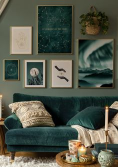 a living room filled with green couches and pictures on the wall above them,