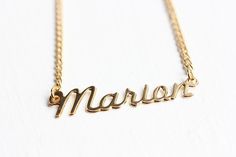 This is a very awesome vintage name necklace. This necklace measures 16" long and the name measures about 1.5" wide total. This is 14k gold plated.Model shown wearing “Marie” name necklace.NOTE: This CAN NOT be custom made. They are vintage, thus you will receive the exact same name in the photo above. We have lots of vintage name jewelry in the shop! You can see them all here at this link:https://www.etsy.com/shop/diamentdesigns/search?search_query=name&order=date_desc&view_type=gallery&ref=sho Vintage Custom Name Jewelry Nameplate, Vintage Nameplate Necklaces, Vintage Custom Nameplate Jewelry, Vintage Custom Name Nameplate Jewelry, Vintage Personalized Nameplate Necklace, Personalized Vintage Nameplate Necklace, Vintage Personalized Name Necklace For Anniversary, Personalized Vintage Name Necklace For Anniversary, Vintage Silver Name Necklace