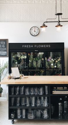 a flower shop with lots of flowers on the counter