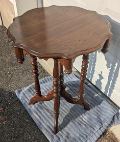 a wooden table sitting on top of a blue rug