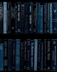 a book shelf filled with lots of books on top of each other in front of a black background