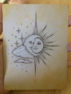 a drawing of the sun and moon on a piece of paper