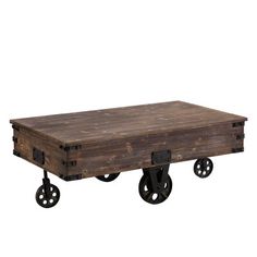 an old wooden table with wheels on the bottom and one end that is turned into a coffee table