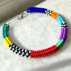 This handmade beaded woven bracelet is carefully hand-woven from the highest quality glass seed beads! Boho style bracelet in vibrant colors sits elegantly on your wrist thanks to its stainless steel extension chain. Multicolor beaded bracelet, compatible with all your clothes that you can use in all seasons, is the ideal handmade gift accessory for you and your loved ones! Unique bracelet guaranteed to get all the compliments! You can click the link for my other handmade jewelry and accessories Multicolor Hand-strung Braided Bangle Bracelet, Multicolor Braided Bead Bangle Bracelet, Multicolor Braided Bracelet Bangle, Multicolor Braided Bangle Bracelet, Multicolor Braided Bracelets With Tiny Beads As Gift, Multicolor Tiny Beads Braided Bracelet As Gift, Multicolor Braided Bracelet With Tiny Beads For Gifts, Colorful Handmade Heishi Beads Bracelets, Multicolor Beaded Braided Bracelet For Beach