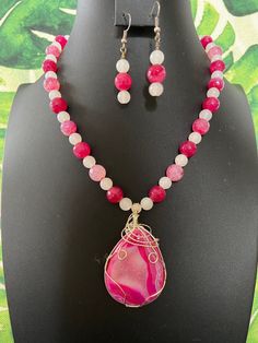 You will receive a gorgeous, hot pink and white, banded agate pendant and beaded necklace with matching earrings. This expertly-wrapped pendant is visually stunning. It is a flatback, but the back is very pretty, too.  I have strung this pendant entirely with round, agate beads.  The pinks are faceted, and some are banded, while others are crackled. The white agate spacers are simply round. I do have other pink agate necklaces listed, so be sure to check the others out and choose the one you lik Adjustable Pink Agate Necklace, Pink Agate Beaded Necklaces, Pink Agate Gemstone Bead Necklace, Pink Agate Beaded Necklace, Pink Agate Beaded Necklaces With Round Beads, Pink Agate Beaded Necklace With Round Beads, Pink Agate Beaded Necklaces As Gift, Pink Agate Pendant Necklace, Pink Agate Gemstone Jewelry