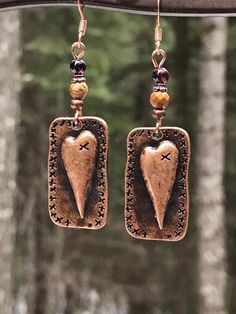 Unique copper heart earrings with Garnet and picture jasper gemstones. You will love these antique copper steam punk heart earrings! Garnet is the stone of love, and it is the perfect complement to the picture jasper stone. These earrings are 2 inches long and 5/8 of an inch wide. They are slightly heavier than most of my other earrings, but not too heavy. Weight is 3.8 grams. The French ear wires are solid copper. All my jewelry comes gift boxed with a custom Shelly Mariposa Design butterfly ca Handmade Bronze Jewelry For Valentine's Day, Bohemian Metal Heart Earrings As Gift, Bohemian Style Heart Earrings As A Gift, Brown Steampunk Jewelry Gift, Steampunk Brown Jewelry For Gift, Steampunk Brown Jewelry For Gifts, Steampunk Brown Jewelry Gift, Hand Forged Vintage Earrings As Gift, Vintage Hand Forged Earrings As Gift