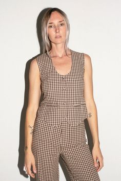 A classic fitting V-neck vest with button front and adjustable back waist. Wear it as a top or over a tee. Fabric is 100% cotton. Ella is 6' tall, 35" bust, 26" waist, 36" hip, and is wearing a size xs. Gingham Vest, Summer Vest, Sailor Pants, Denim Branding, High Waisted Pants, Soho, Casual Pants, Gingham, High Waist