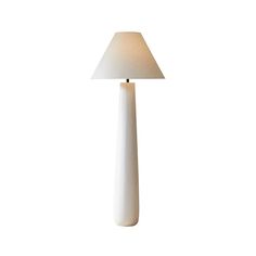 a white lamp with a beige shade on it