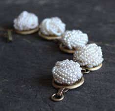 "How cool is this? Pefectly preserved pearly white bead clip on earrings, vintage 50's and 60's, make this a really fun bracelet, that definitely makes people take notice. This is a rich looking bracelet that can be dressed up or down. These earrings are harder to find than I thought they would be. But the hunt sure is fun. 7 1/2\" long. I work with antique and vintage parts. Some may show signs of wear or age. Please look at each picture closely. I have tried to show all aspects of my work. Ple Handmade Vintage Cream Bracelets, Vintage Handmade Cream Bracelets, Adjustable Vintage Pearl White Jewelry, Vintage Adjustable Pearl White Jewelry, Vintage Pearl White Jewelry For Party, Antique White Pearl Jewelry, White Pearl Button Jewelry For Party, White Jewelry With Pearl Buttons For Parties, Vintage Handmade Cream Jewelry