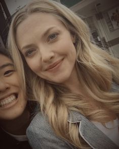 two women are smiling and posing for the camera