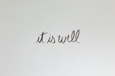 the word it's well written in cursive writing on a white wall