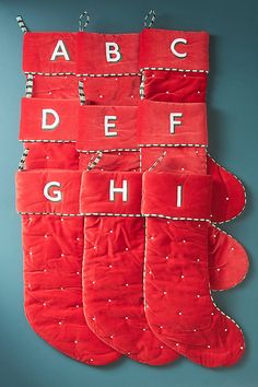 a red christmas stocking hanging on the wall with letters and numbers written in it