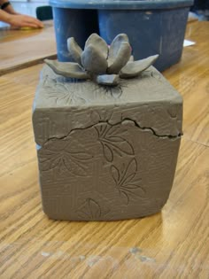 a clay block sitting on top of a wooden table