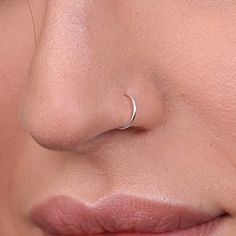 a woman's nose with a small nose ring on it