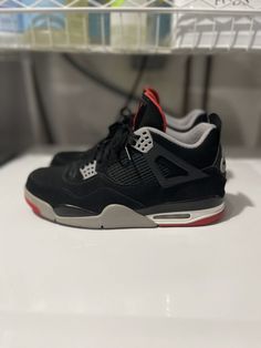 This Jordan 4 Bred 2019 sneaker is a perfect addition to any sneakerhead's collection. With a stylish low-top shoe shaft, this athletic shoe comes in a striking black, red, and white colorway that is sure to turn heads. The sneaker features a size 12 US shoe size, making it a comfortable fit for men. The Air Jordan 4 model is a classic, and this 2019 release is no exception. With a product line that is synonymous with quality, this sneaker is perfect for those who want a colorful and stylish shoe that can be worn for athletic activities or everyday wear. The style code for this sneaker is 308497060, and it is a must-have for any fan of the Air Jordan product line. Sorry no box Jordan 4 Bred, Jordan 4’s, Fit For Men, Athletic Shoe, Air Jordan 4, Stylish Shoes, Top Shoes, Sneaker Head, Low Top