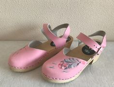 "Pink Clogs Swedish Women Shoes Pink Wooden Clogs Leather Shoes Eco friendly Wooden Sandals Made in Sweden Size 38 Length: 9 3/4\"/ 25 cm  Heel height: 2.5\"/ 6 cm Condition: Good Vintage Condition N.B. Color may slightly differ from picture. SHIPPING * Items are shipped 1 - 3 business days after receiving the payment. * I ship from Europe, so please allow 2 to 3 weeks for the package to arrive if you live overseas. * Europe 5 - 10 business days. 47" Pink Platform Clogs With Open Heel, Pink Sandals With Wooden Heel For Spring, Spring Clogs With Heel Loop And Round Toe, Beach Clogs With Heel Strap, Pink Mules With Wooden Heel For Spring, Beach Slip-on Clogs With Heel Loop, Beach Clogs With Heel Strap And Open Heel, Spring Pink Mules With Wooden Heel, Casual Pink Mules With Wooden Heel