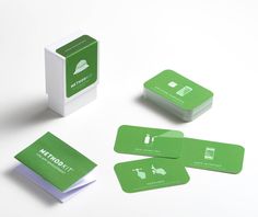 green business cards with white envelopes sitting next to each other